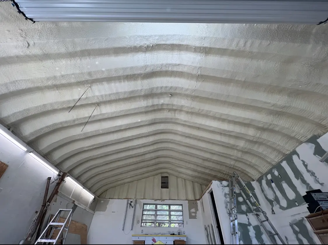 Spray polyurethane foam applied to the underside of a metal roof deck in Davis